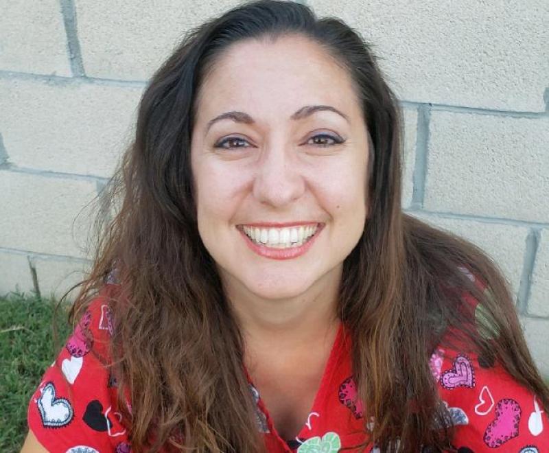 Anna McClain holding three small dogs