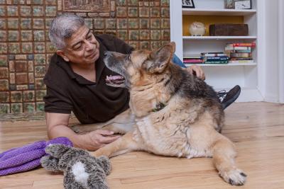 Jaime Gallardo and Dublin the dog lying next to each other looking at one another
