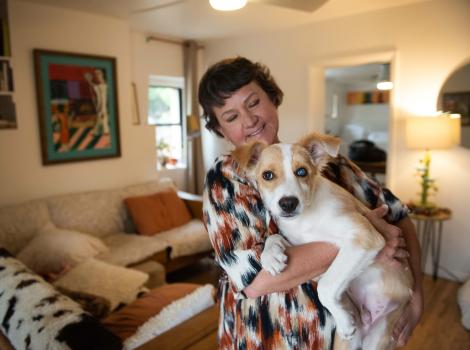 Karen holding Halo the puppy in a home