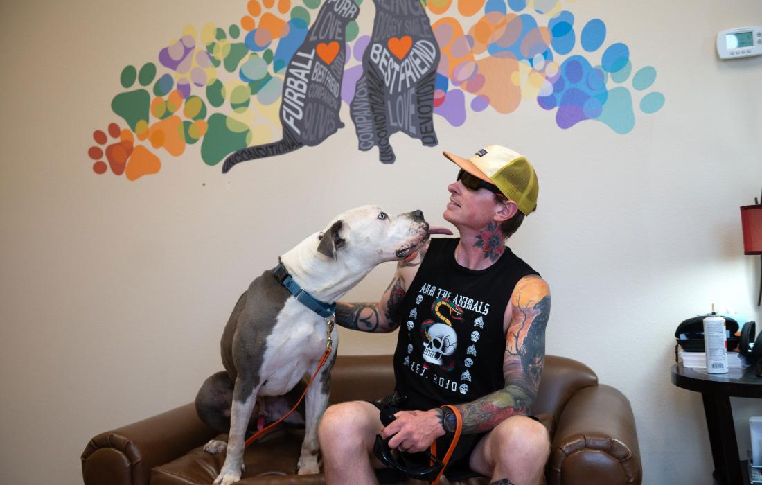 Josh the dog licking Best Friends caregiver Pete O’Dea's face