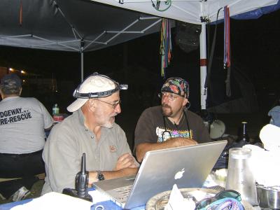 Best Friends co-founder Francis Battista and another person by a laptop computer at the Best Friends staging area following Hurricane Katrina