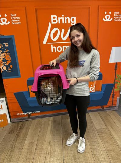 Goldilocks in a carrier held by a smiling person