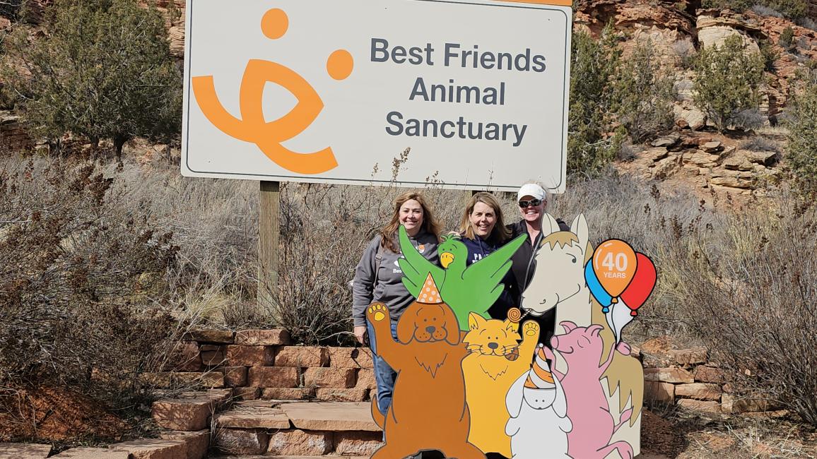 Rochelle and two others at the Best Friends sign by the Welcome Center