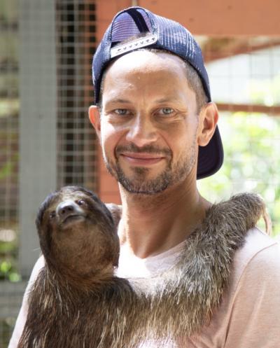 Simeon Gilmer holding a sloth